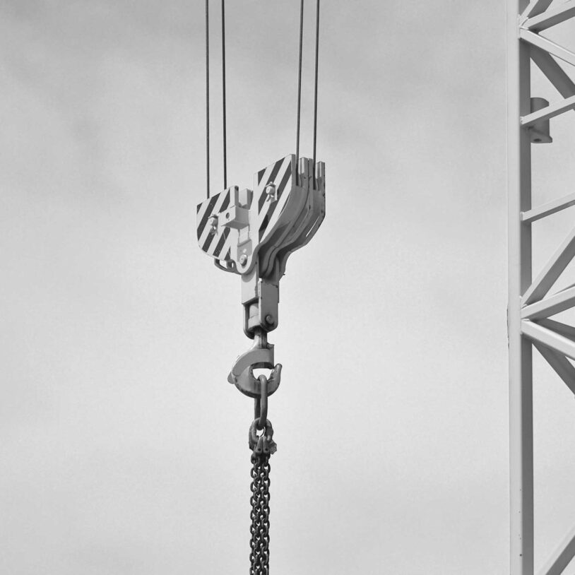 Suspended lifting hook on crane to represent Construction industry and Industries