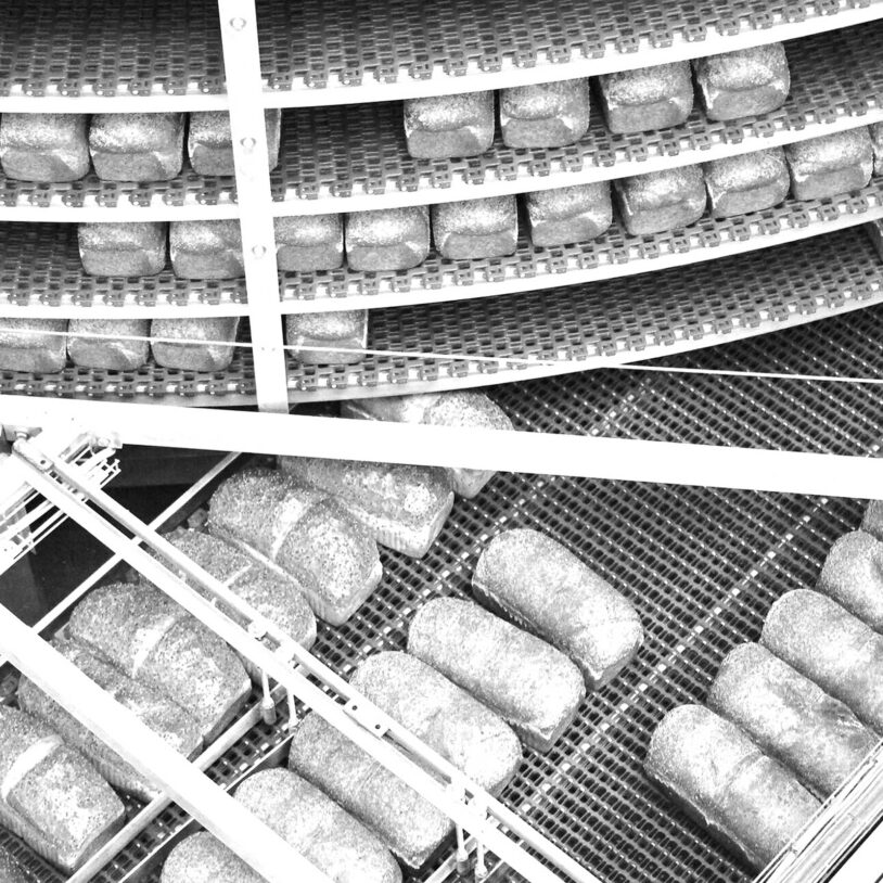 Overhead image of loaves of bread on conveyor belt to represent Food Industry and Industries