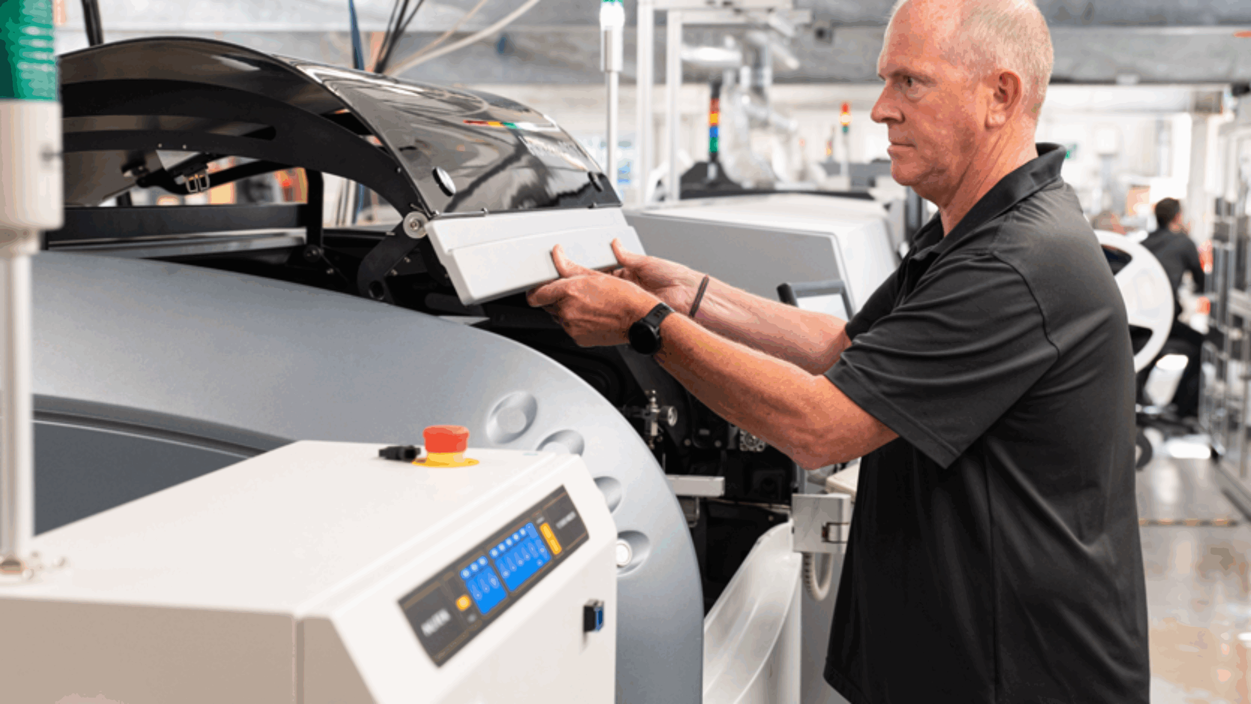 Mantracourt Electronics employee lifting lid on pick and place machine